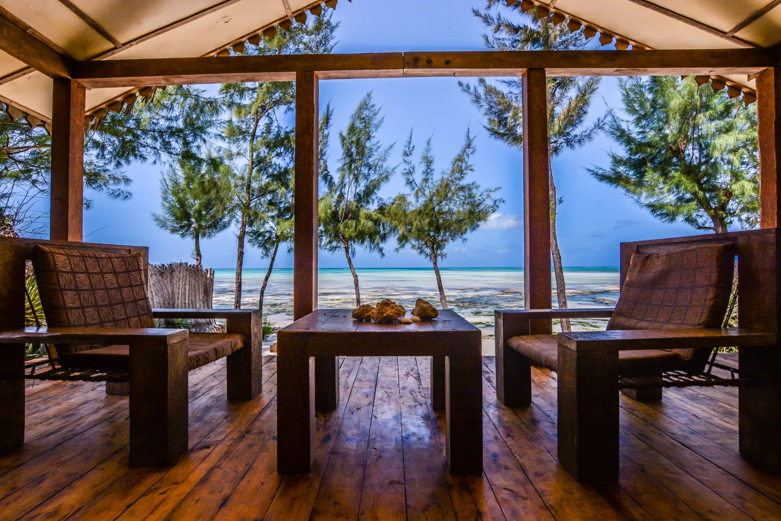 A verandah at Seasons Lodge looking out through the casuarina trees to the sea